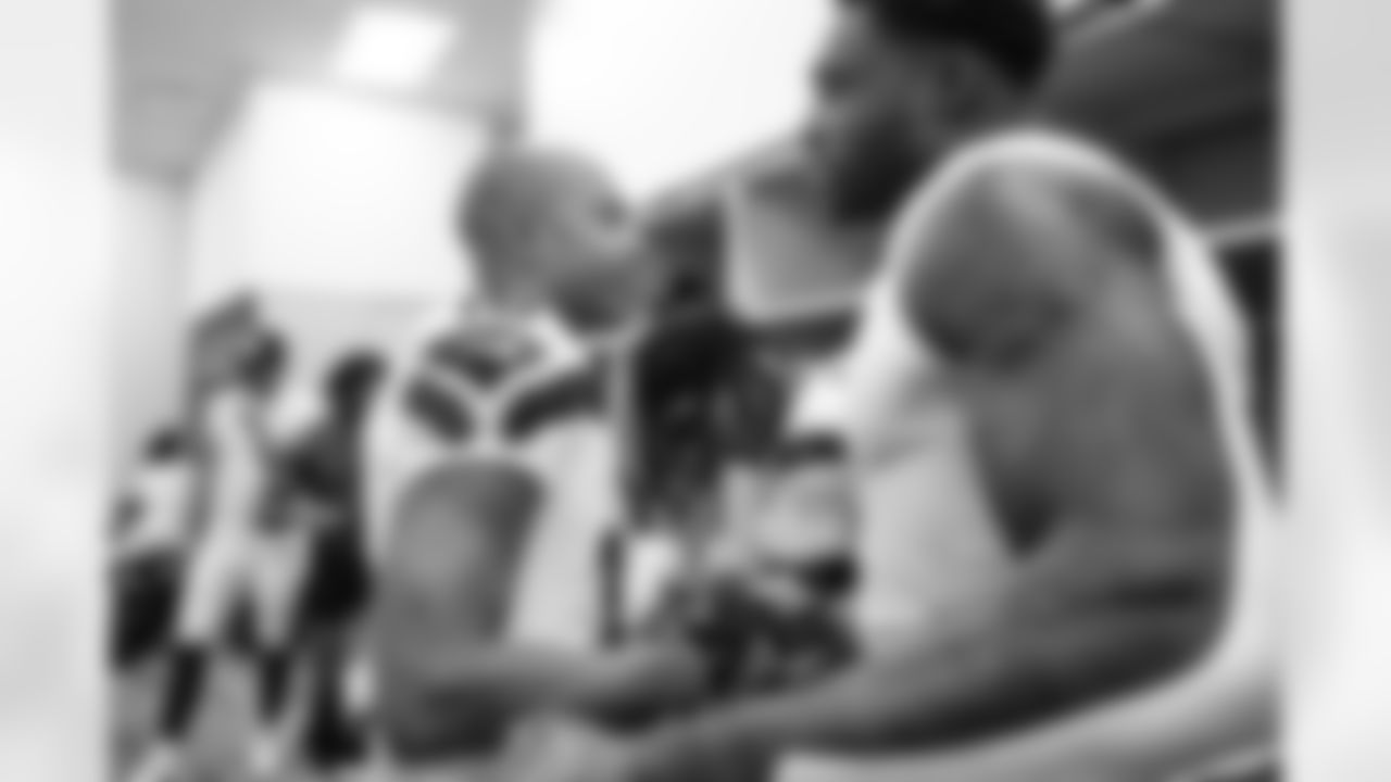 Receivers Tyler Lockett and DK Metcalf shake hands in the locker room after the game.