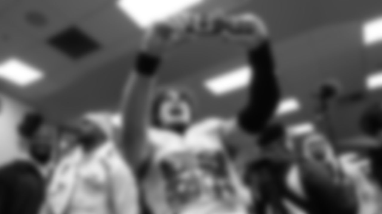 Tight end AJ Barner snaps a photo in the locker room.