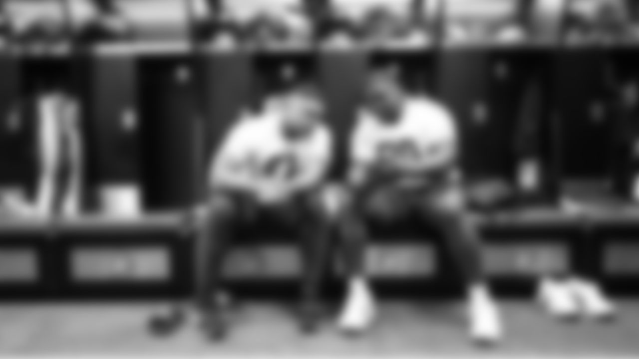 Seahawks defensive linemen Byron Murphy II and Jarran Reed relax in the locker room at the practice facility.