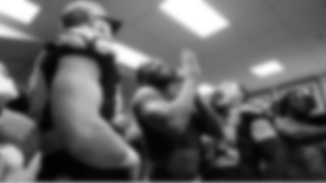 Seahawks linebacker DeMarcus Lawrence smiles as he is awarded a game ball.