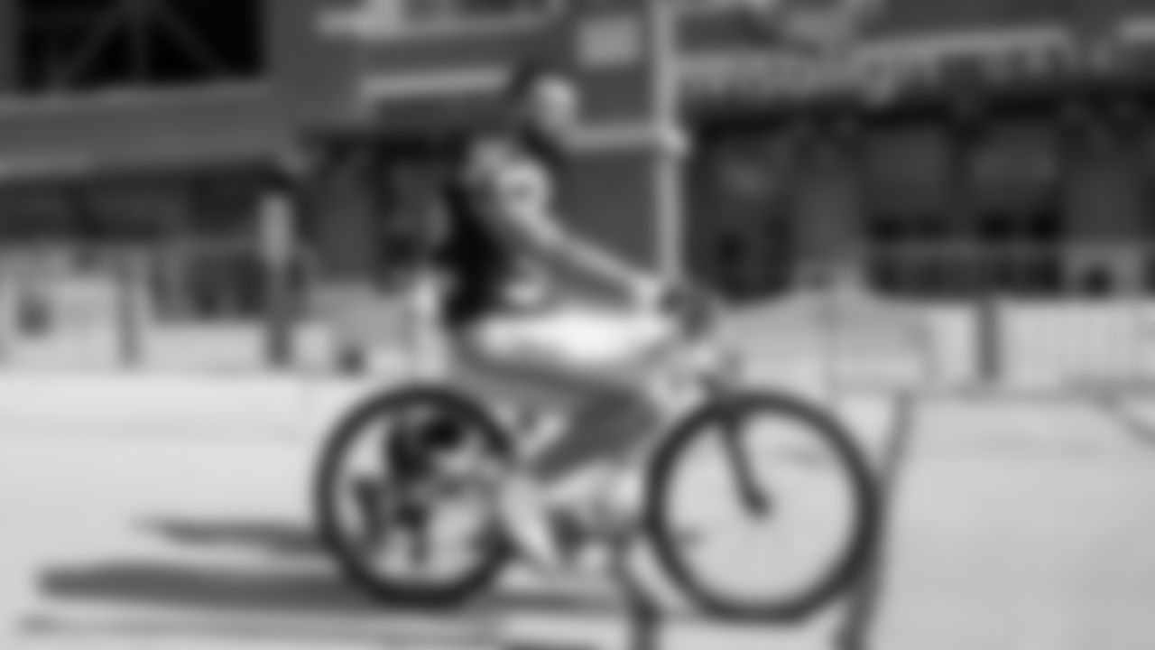 Seahawks linebacker Patrick O'Connell (52) rides a bike on their way to practice on August 21, 2025 in Green Bay, Wisconsin.