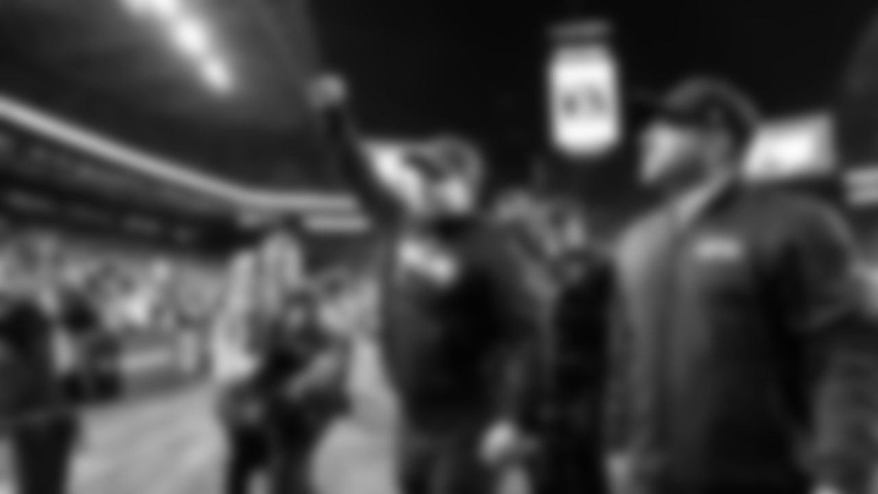 Head coach Mike Macdonald salutes the 12s as he walks off the field with a victory.