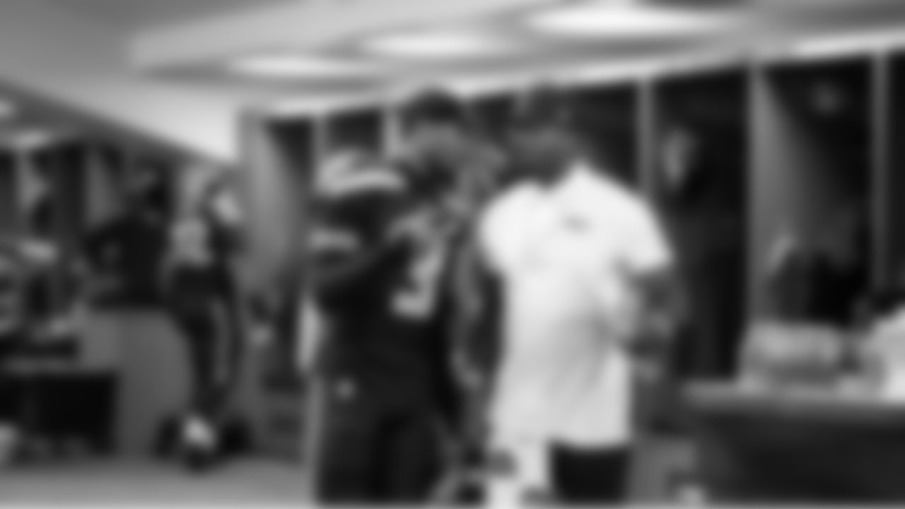 In the locker room, Nick Emmanwori confers with assistant coach Neiko Thorpe.