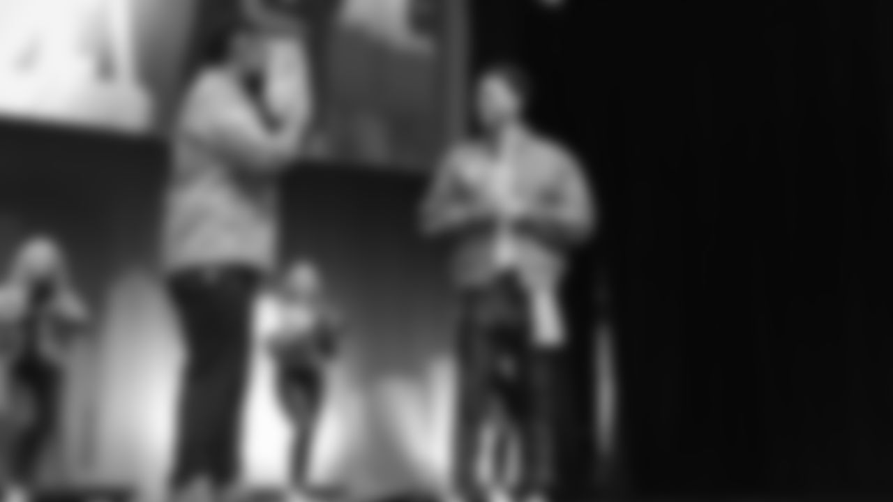 Jaedin speaks with Gee Scott during the Seahawks Dancers performance and meet and greet in Ticketmaster Tailgate.