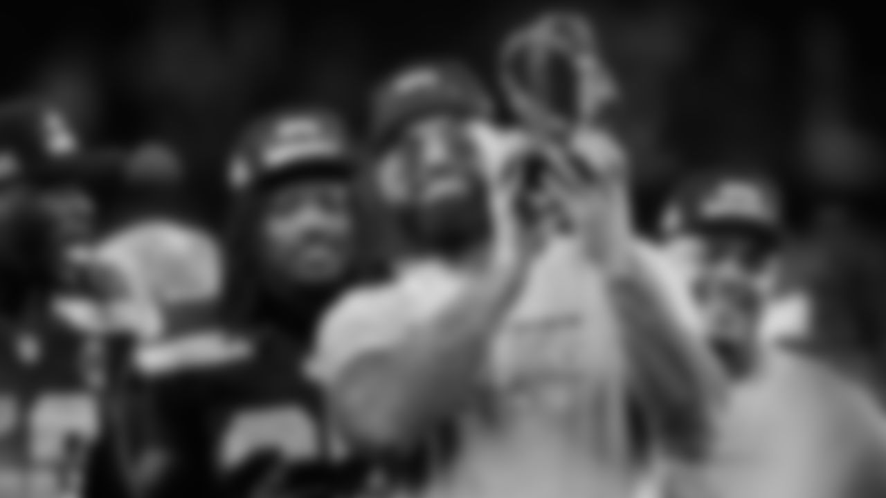 Seattle Seahawks offensive tackle Abraham Lucas, foreground, celebrates with teammates after the NFC Championship NFL football game against the Los Angeles Rams, Sunday, Jan. 25, 2026, in Seattle. (AP Photo/Stephen Brashear)