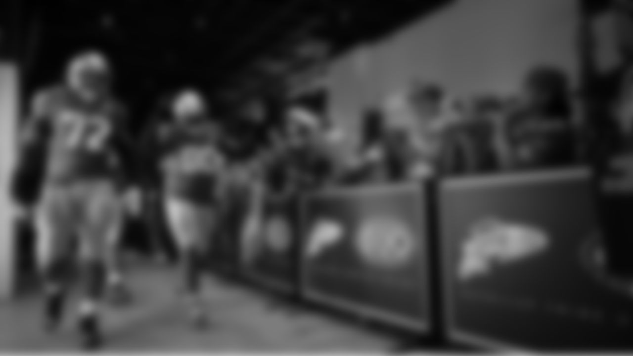 Seahawks tackle Abraham Lucas (72) and defensive tackle Jarran Reed (90) walk through the Emerald Queen Casino tunnel club at Lumen Field for the Week 5 matchup vs. the Buccaneers.