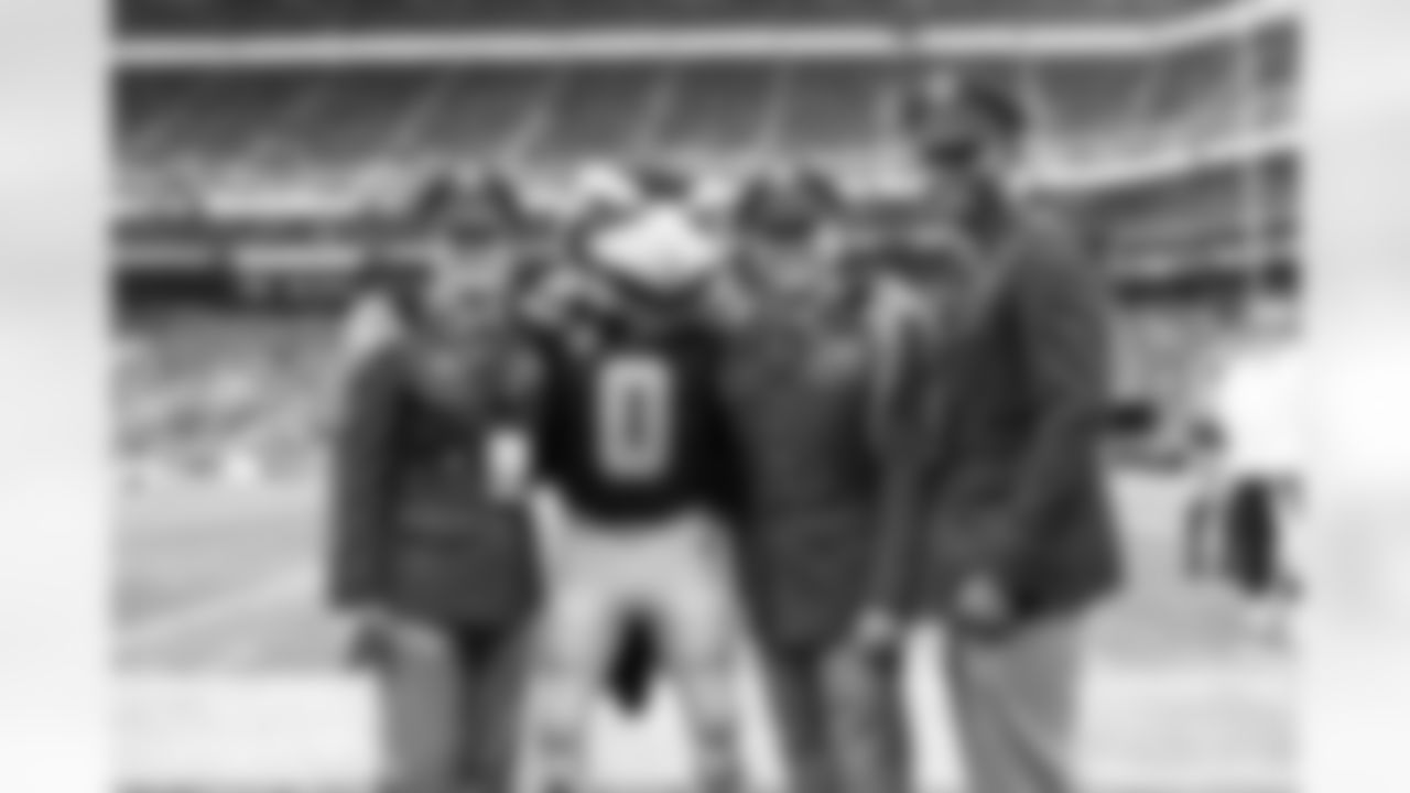 Seahawks mascot "Blitz" poses with members of the United States military before the game.