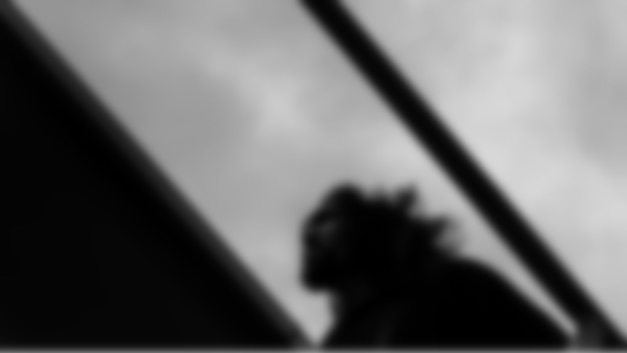 On a rainy, blustery October day, Seahawks defensive end Leonard Williams heads up the stairs for the team's charter flight for the Sunday Night Football game against the Washington Commanders.