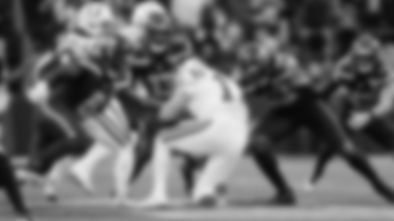 Seattle's DeMarcus Lawrence and Derick Hall close in on Colts quarterback Philip Rivers.