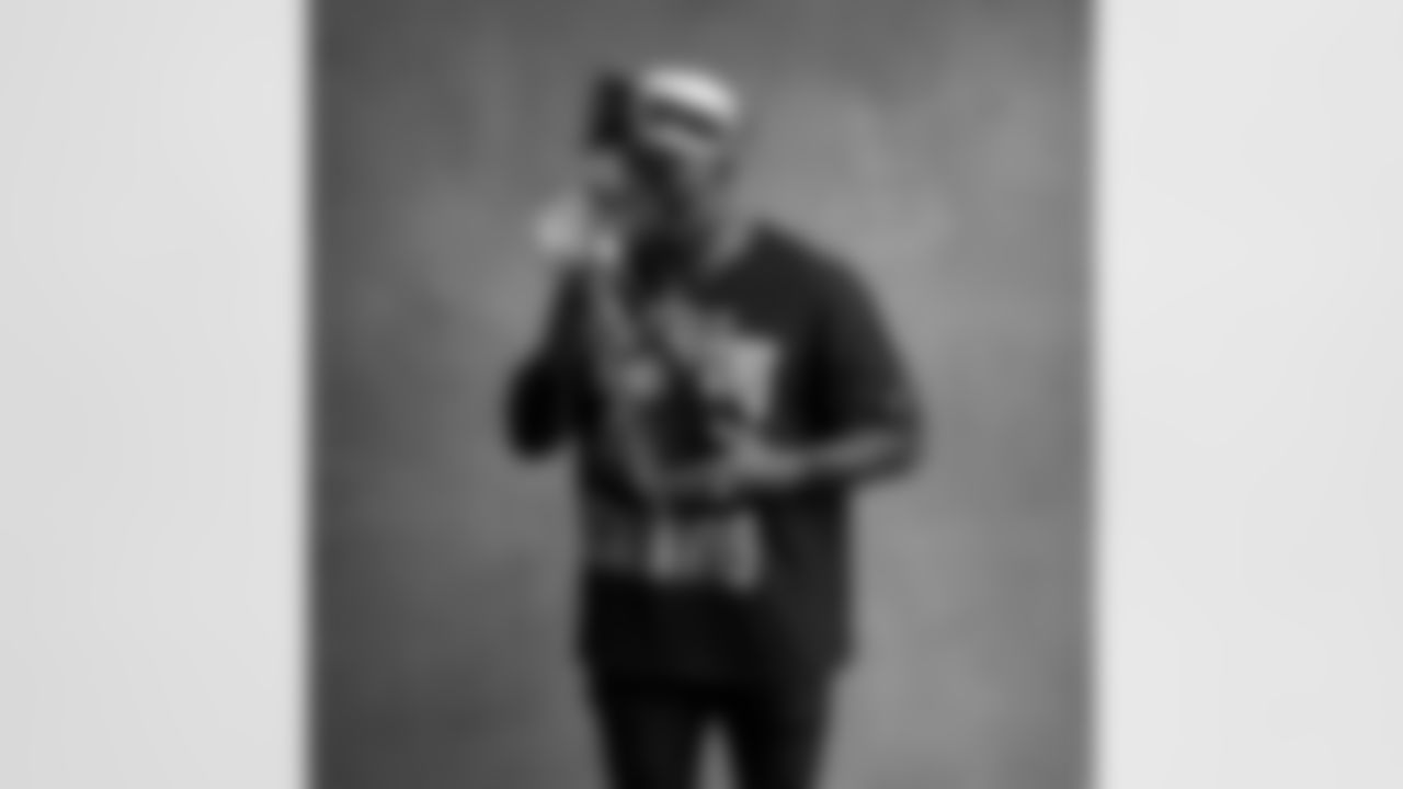 Seahawks linebacker Derick Hall (58) with the Lombardi Trophy after winning Super Bowl LX.