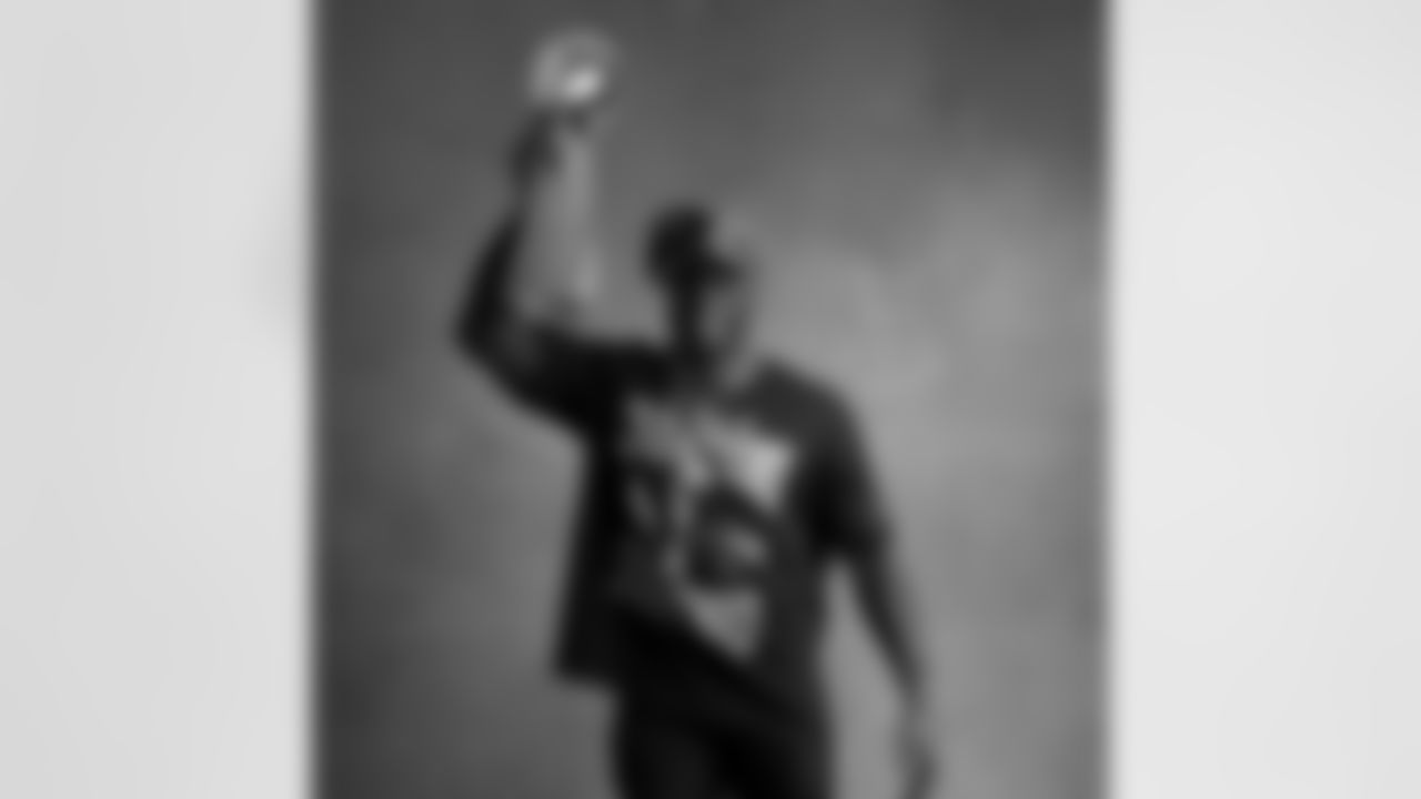 Seahawks linebacker Derick Hall (58) with the Lombardi Trophy after winning Super Bowl LX.