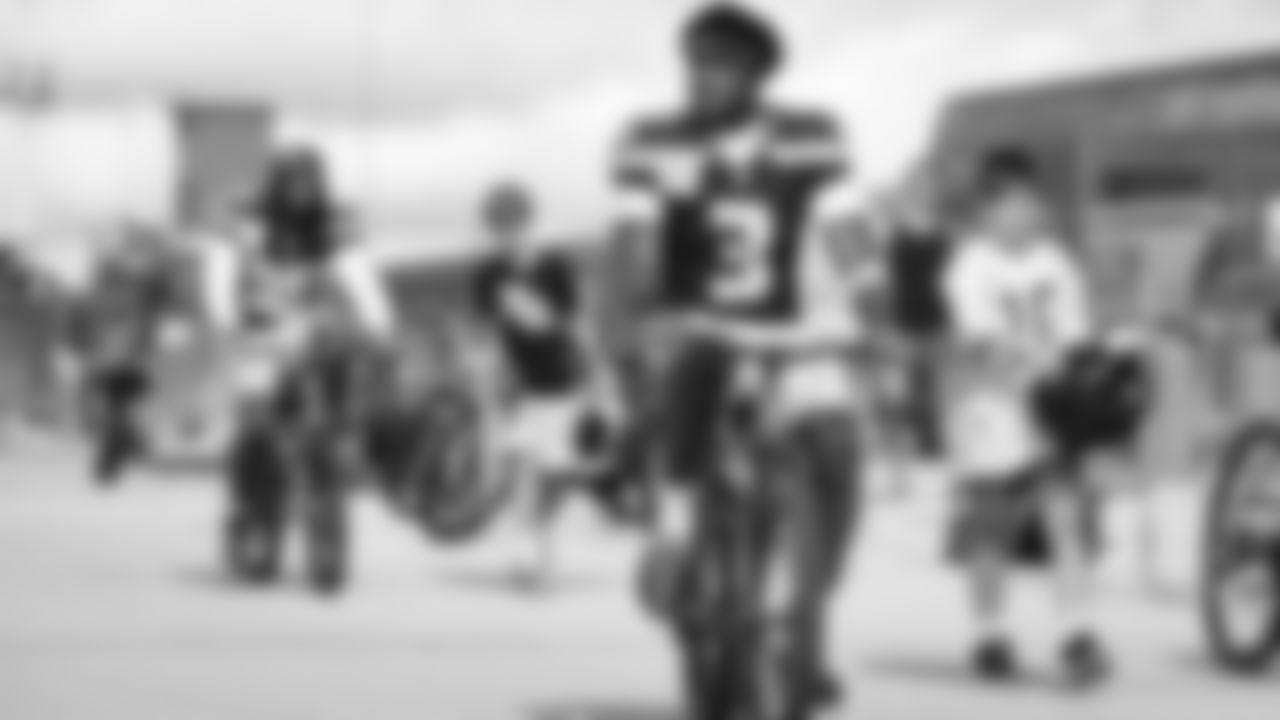 Seahawks safety Nick Emmanwori (3) rides a bike on their way to practice on August 21, 2025 in Green Bay, Wisconsin.
