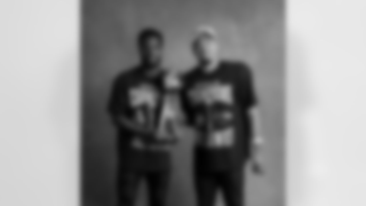 Seahawks cornerback Devon Witherspoon (21) and wide receiver Jaxon Smith-Njigba (11) with the Lombardi Trophy after winning Super Bowl LX.