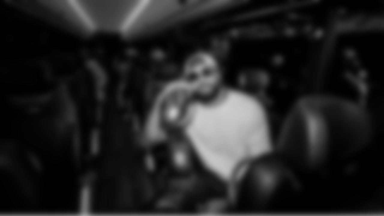 Seahawks safety Julian Love, who had an interception in the Super Bowl victory, cradles the Lombardi Trophy on the bus from the stadium to the team's victory party.