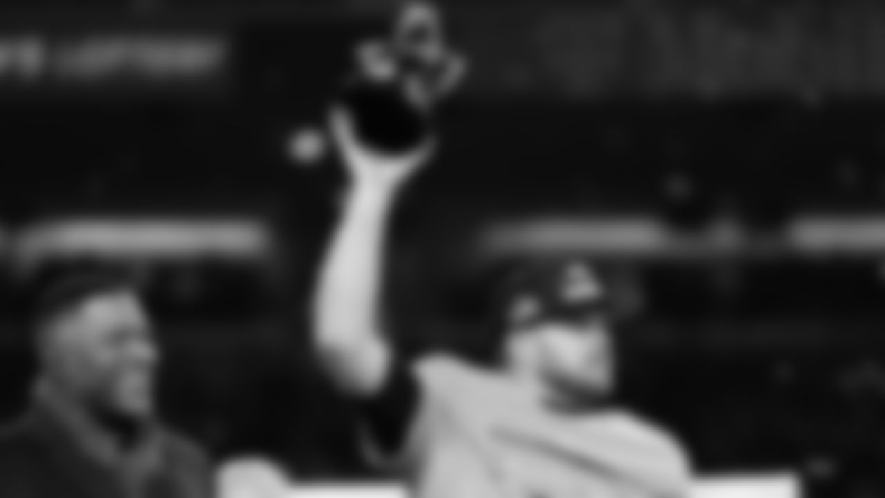 Michael Strahan, left, watches as Seattle Seahawks quarterback Sam Darnold celebrates after the NFC Championship NFL football game against the Los Angeles Rams, Sunday, Jan. 25, 2026, in Seattle. (AP Photo/Godofredo A. Vásquez)