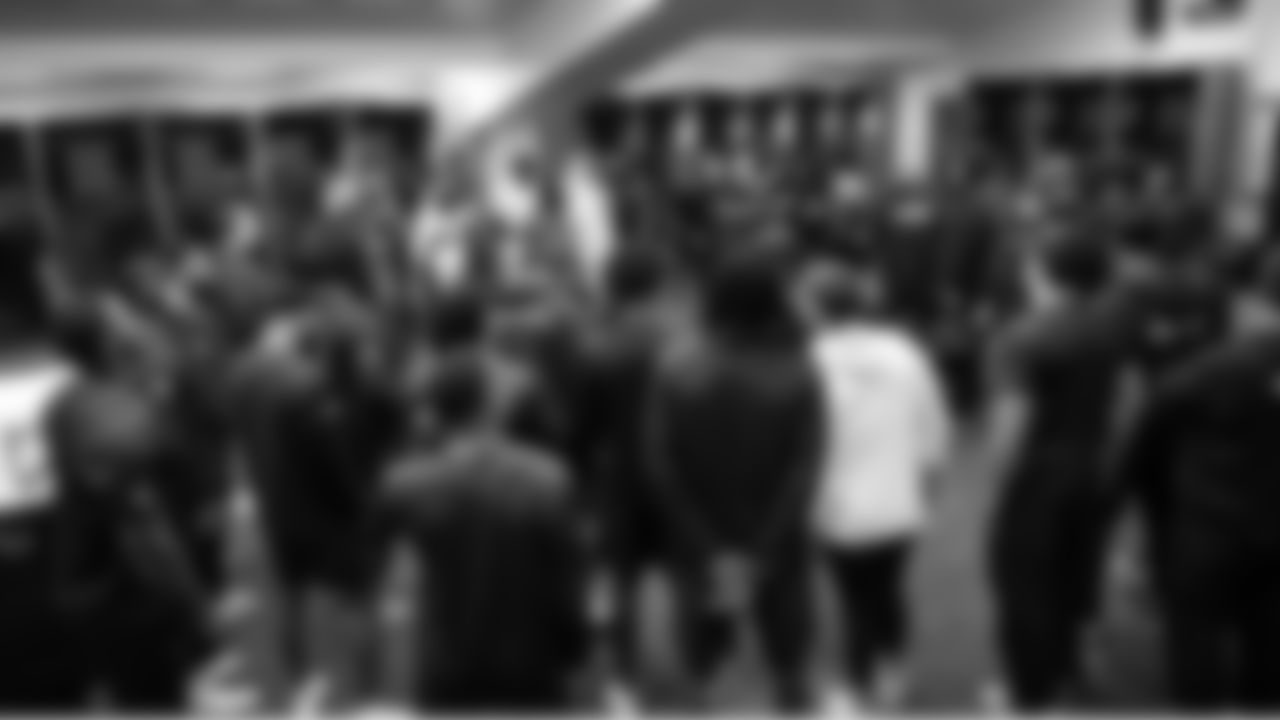 Members of the Seahawks defense meet in the locker room.