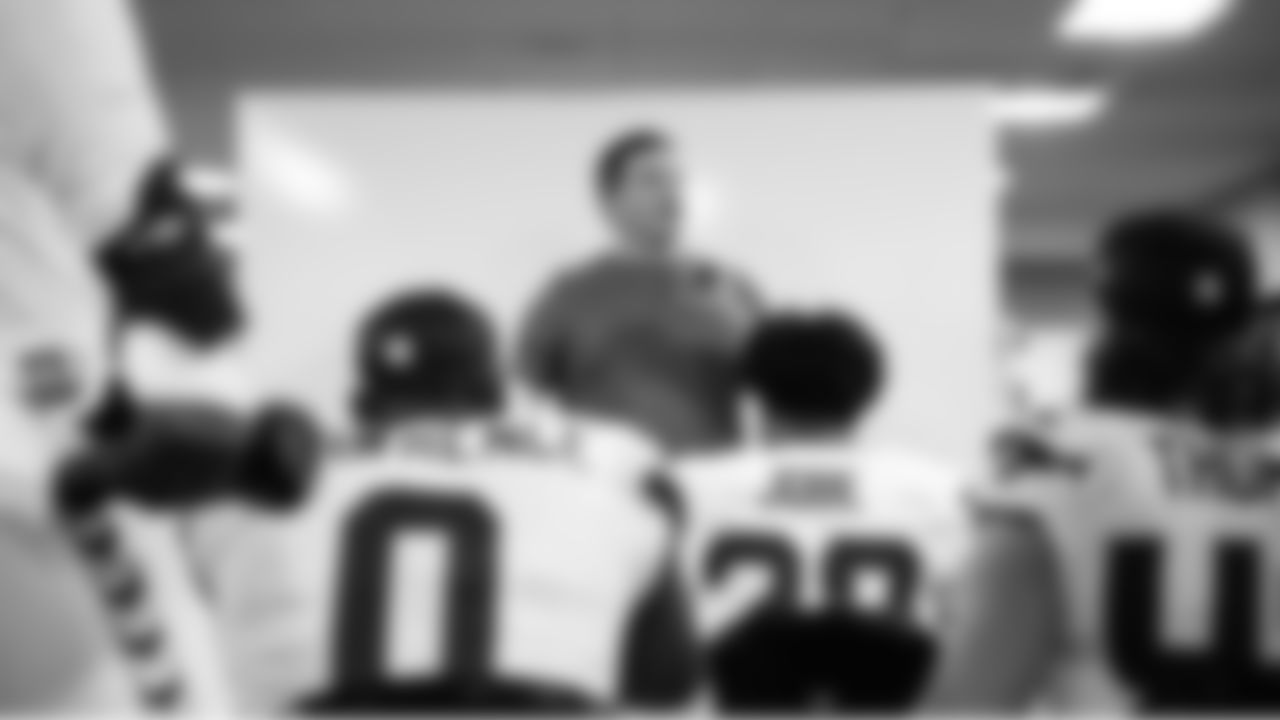 On the other end of the locker room, head coach Mike Macdonald speaks to the defense.