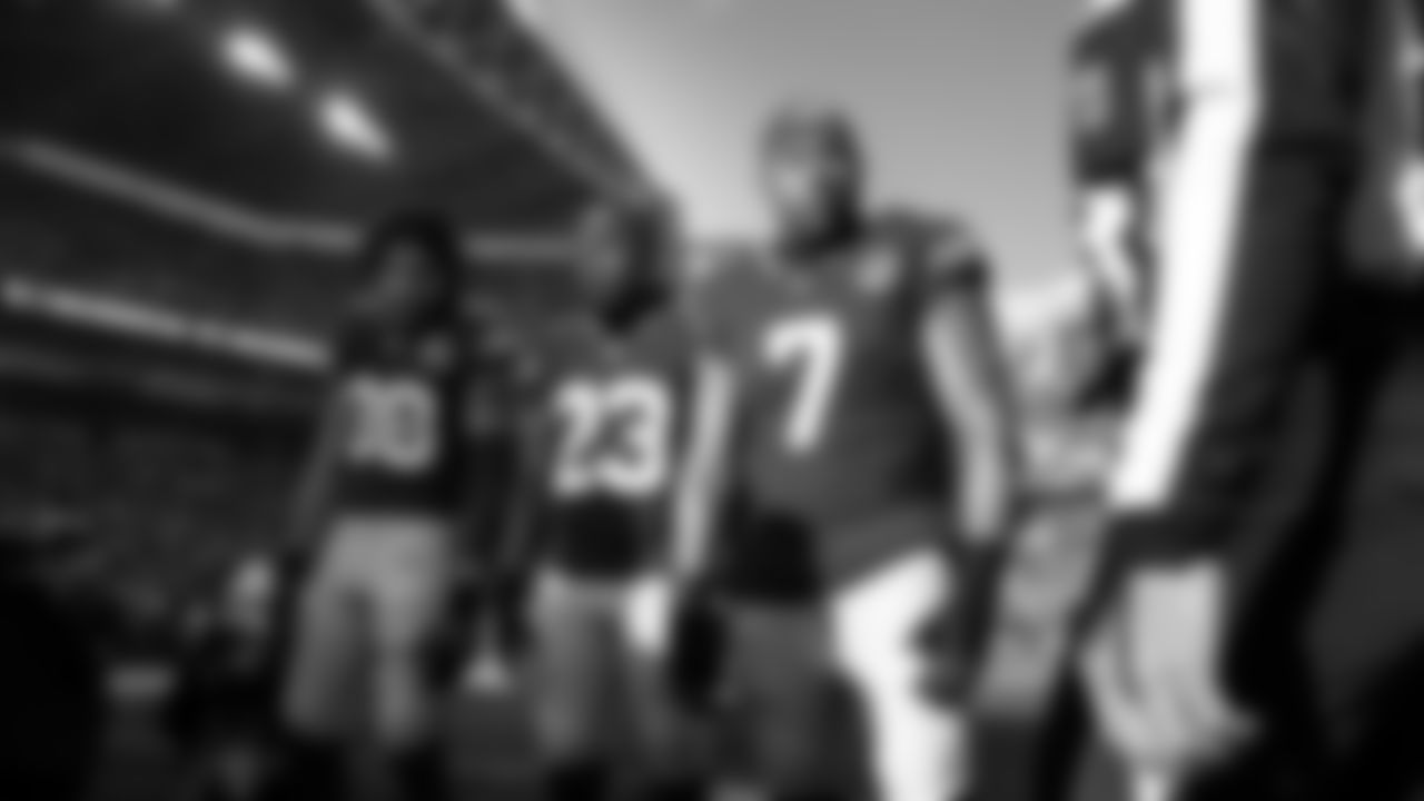 Seahawks game captains AJ Barner, D'Anthony Bell and Uchenna Nwosu at midfield for the pregame coin toss.