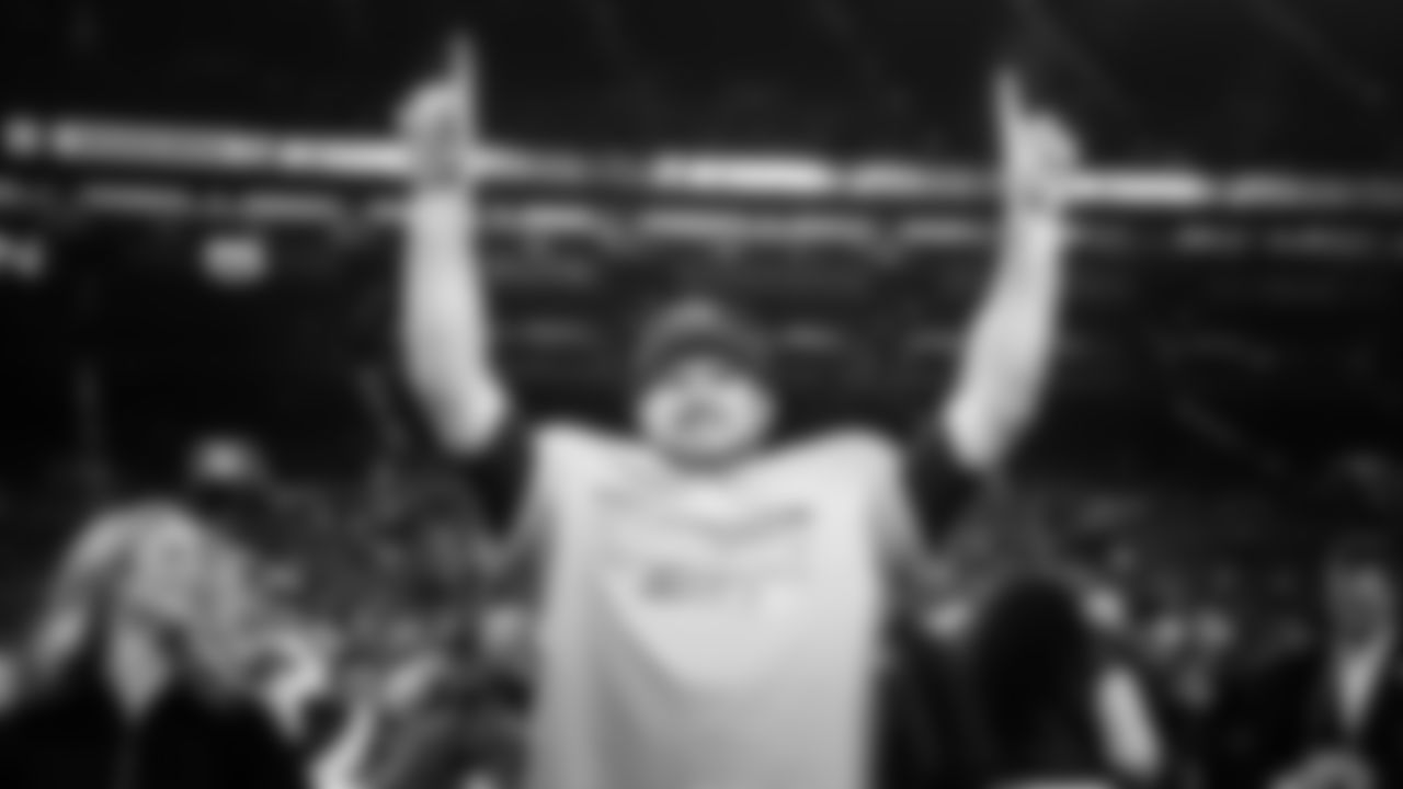 Seahawks quarterback Sam Darnold celebrates while wearing his NFC Champions t-shirt.