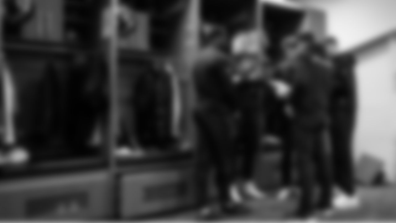 Quarterbacks Sam Darnold, Drew Lock and Jalen Milroe meet with coaches Klint Kubiak and Andrew Janocko in the locker room before the game.