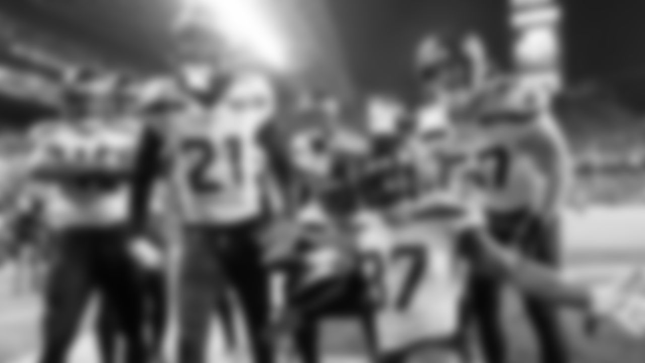 Seahawks defenders celebrate after a fourth quarter interception by cornerback Tre Flowers.