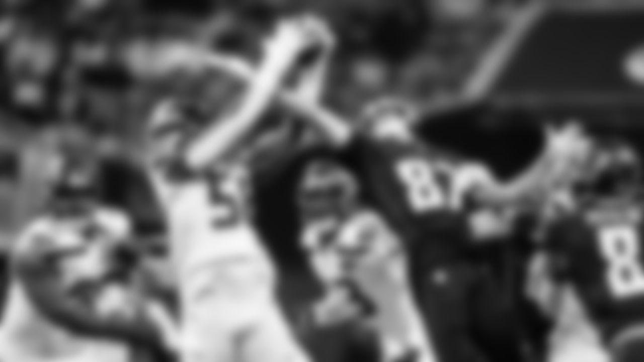 Seattle's Derick Hall tries to intercept a pass knocked into the air by teammate Devon Witherspoon that Witherspoon ended up catching.