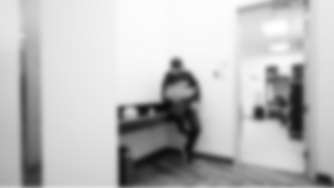 Seahawks offensive coordinator Klint Kubiak reviews his playsheet in the locker room before the game.