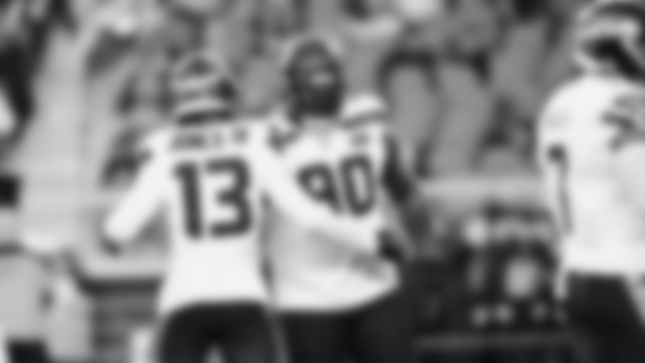 Seahawks linebacker Ernest Jones IV (13) and defensive tackle Jarran Reed (90) warms up at Levi's Stadium for the Week 18 matchup vs. the 49ers.