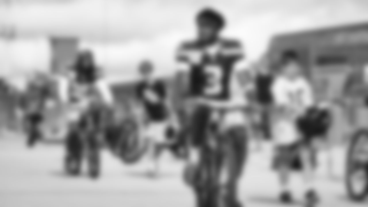 Seahawks safety Nick Emmanwori (3) rides a bike on their way to practice on August 21, 2025 in Green Bay, Wisconsin.
