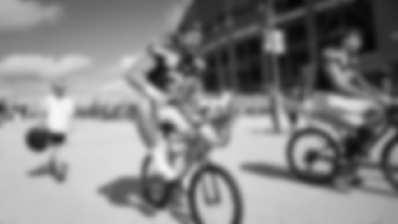 Seahawks fullback Brady Russell (38) rides a bike on their way to practice on August 21, 2025 in Green Bay, Wisconsin.