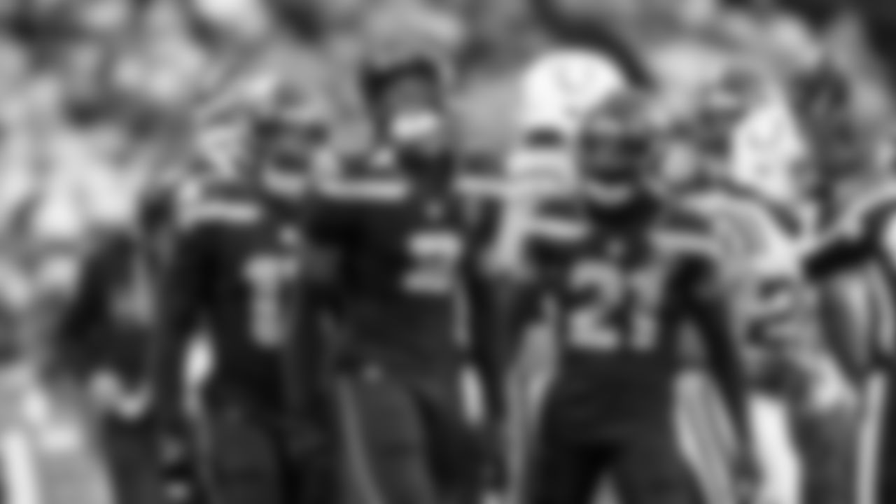 Seattle safety Nick Emmanwori lets out a yell after a stop, joined by Ernest Jones IV and Devon Witherspoon.