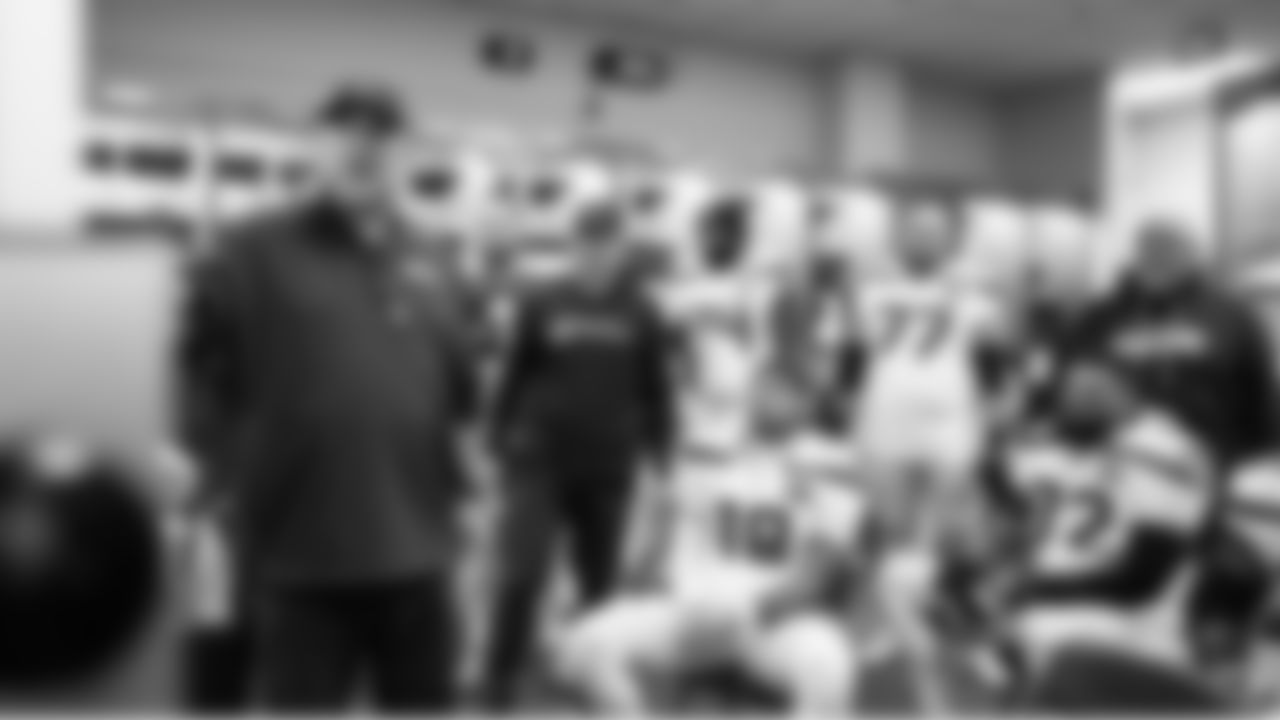 Offensive line coach John Benton talks to the offense in the locker room at halftime.