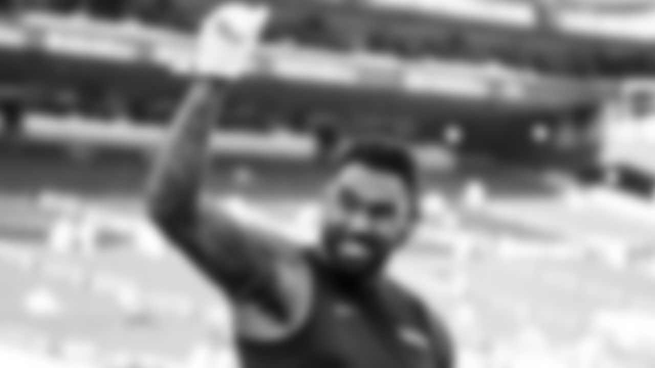 Seahawks defensive end Leonard Willams acknowledges the 12s as he takes the field for early warmups.