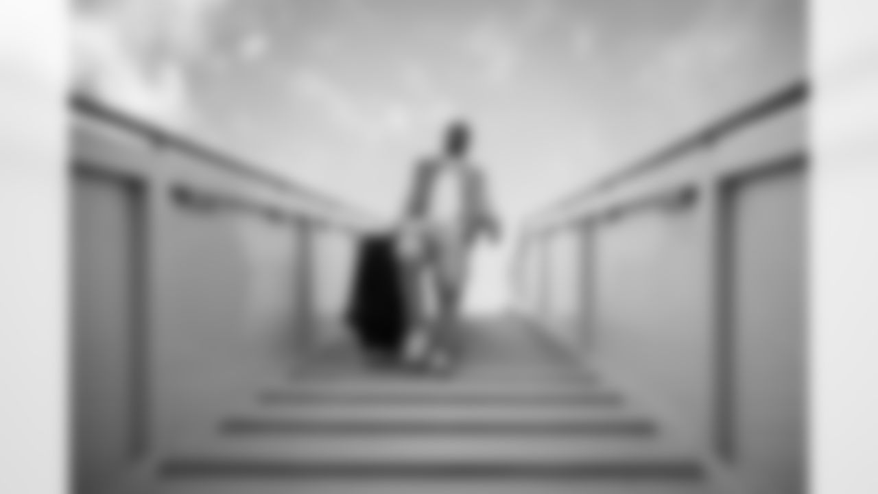 Tyler Lockett walks down the stairs from the plane to the waiting buses after the team landed in Los Angeles.