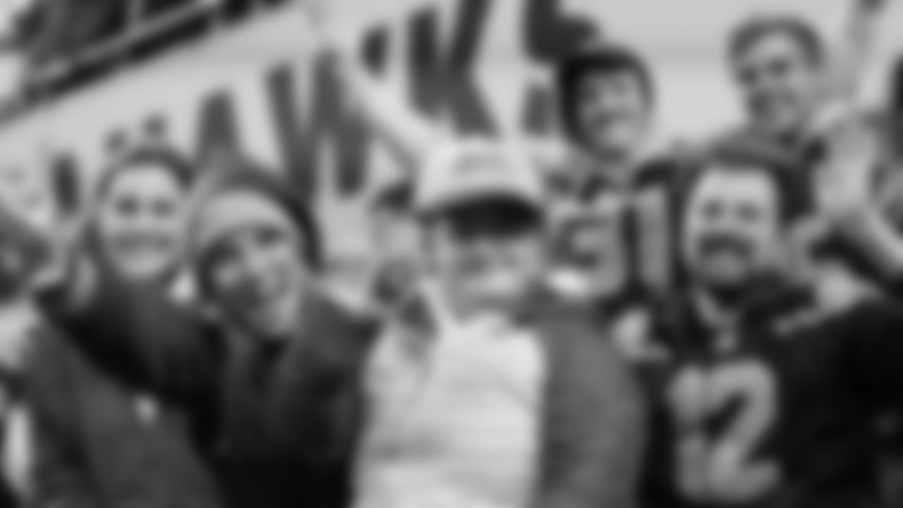 Seahawks fan Maddie, wearing a Rivalries cap, cheers on her favorite team from the Red Zone Suites.