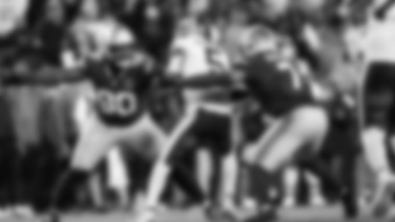 Seattle's Jarran Reed and Uchenna Nwosu combine to sack Commanders quarterback Jayden Daniels.