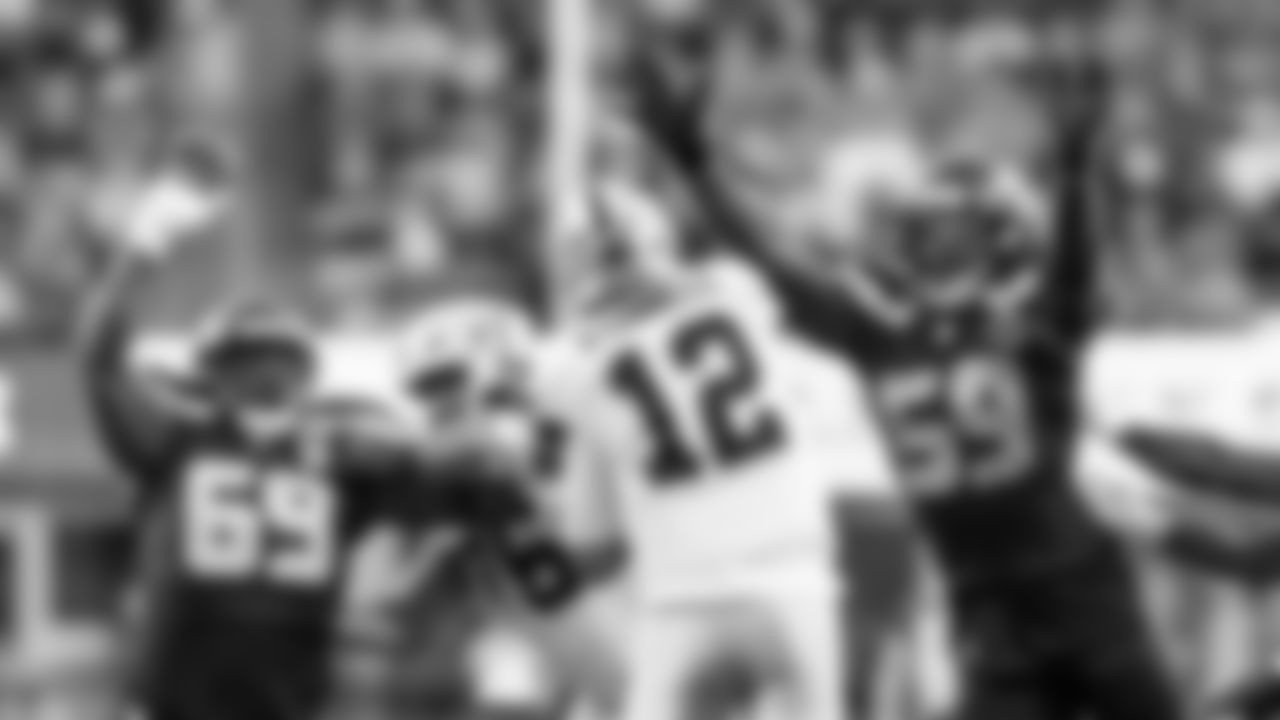 Seahawks linebacker Tyreke Smith and defensive tackle Bubba Thomas pressure Raiders quarterback Aidan O'Connell.