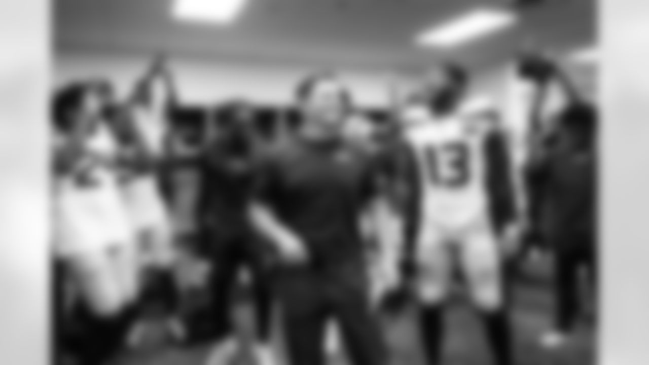 The Seahawks, with head coach Mike Macdonald, celebrate the victory in the locker room after the game.
