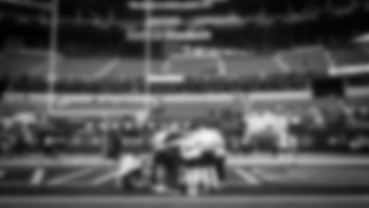 Seahawks offensive skill players huddle at the end of their early pregame warmup at SoFi Stadium.