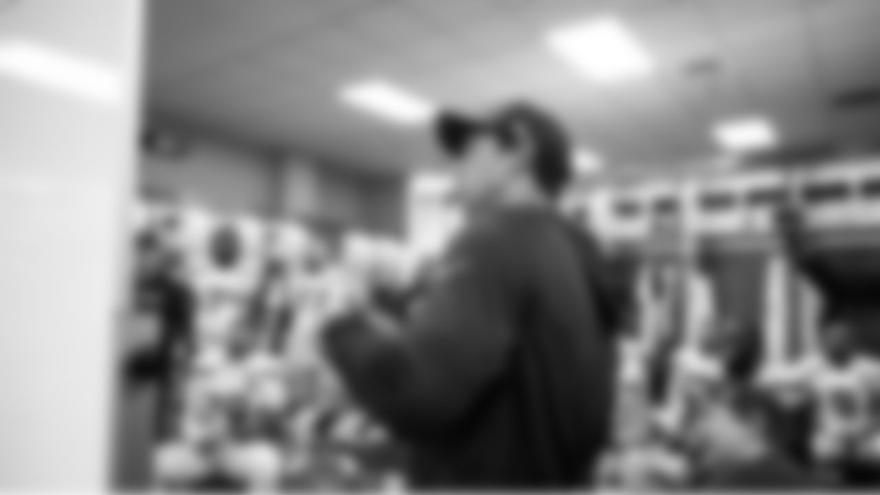 At halftime, offensive coordinator Klint Kubiak meets with his players.