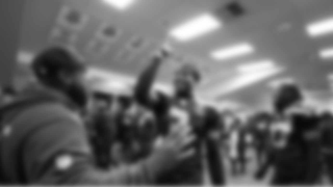 Nick Emmanwori celebrates in the locker room.