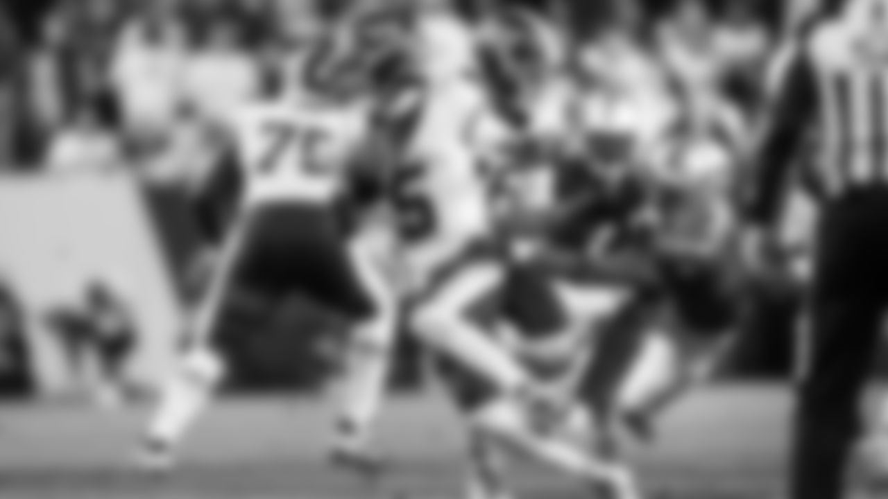 Blitzing Seahawks defensive back Nick Emmanwori gets ahold of Commanders quarterback Jayden Daniels.