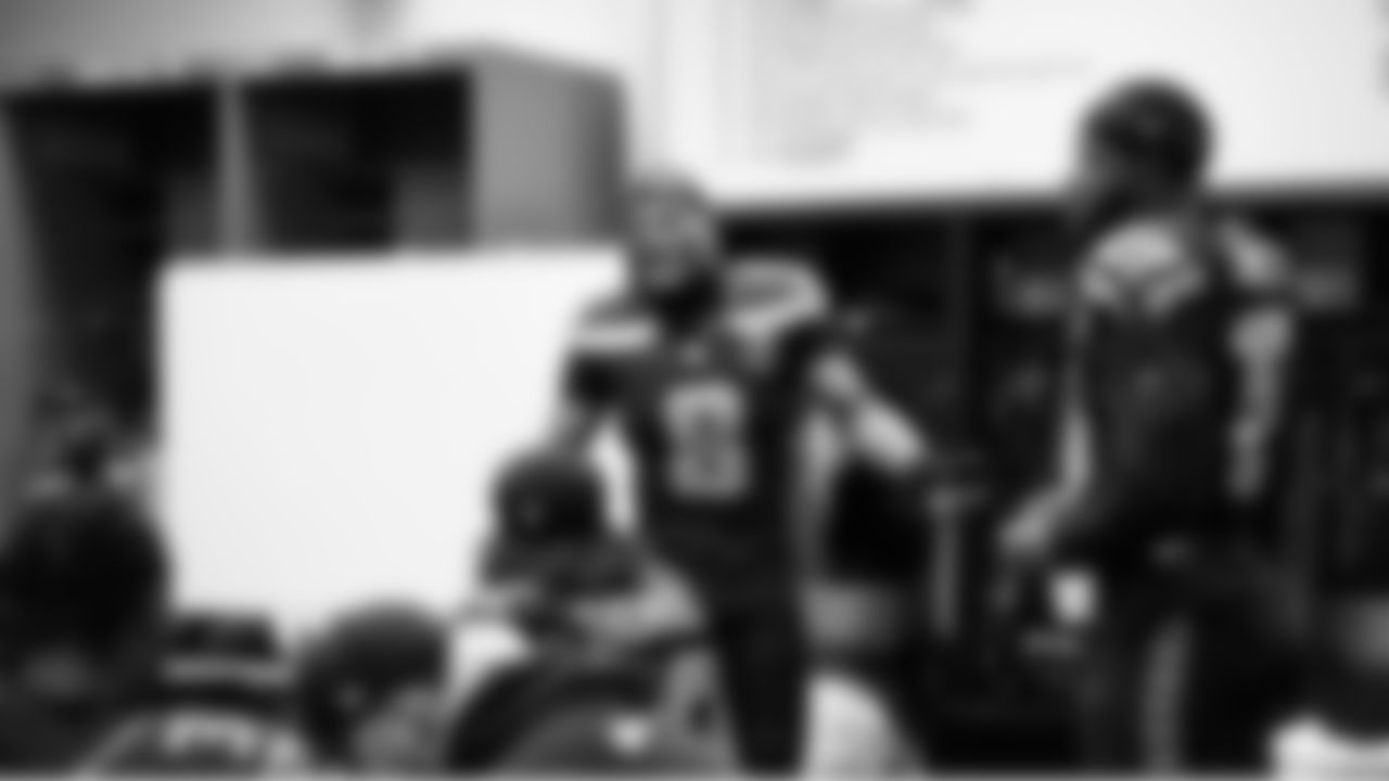 Seahawks safety Coby Bryant speaks to teammates during halftime.