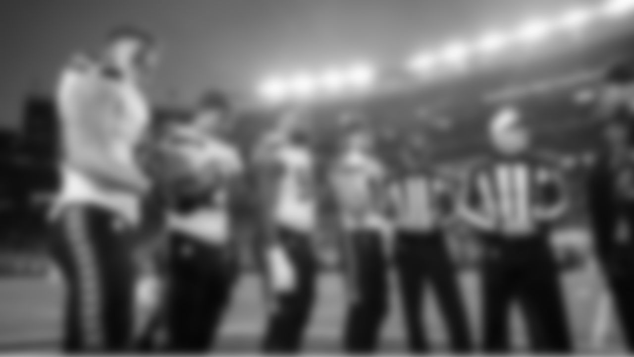 Seahawks game captains Eric Saubert, Zach Charbonnet, Leonard Williams and Jake Bobo attend the coin toss at midfield.