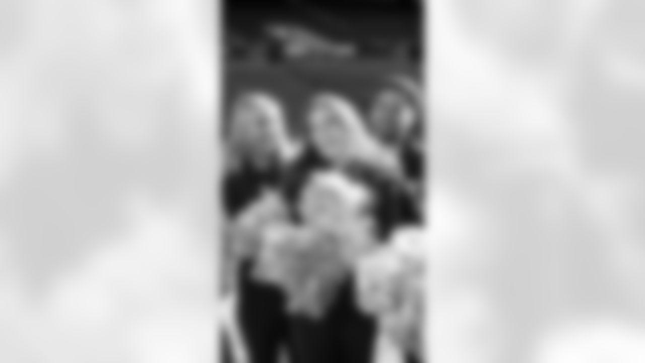 Macy finding out she is the Dancer of the Day at pregame rehearsal and celebrates with her teammates.