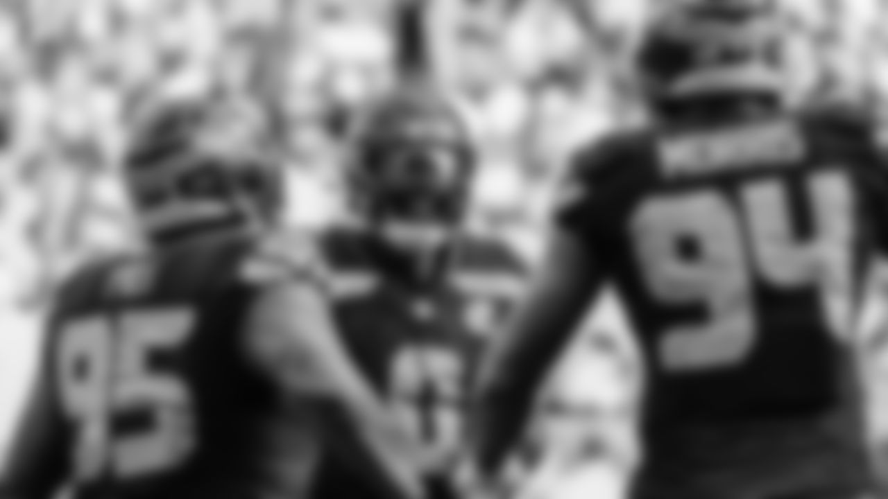 Seahawks linebacker Tyrice Knight (48) sacks Cardinals QB Jacoby Brissett and defensive end DeMarcus Lawrence (0) scoops the ball up and scores the touchdown.