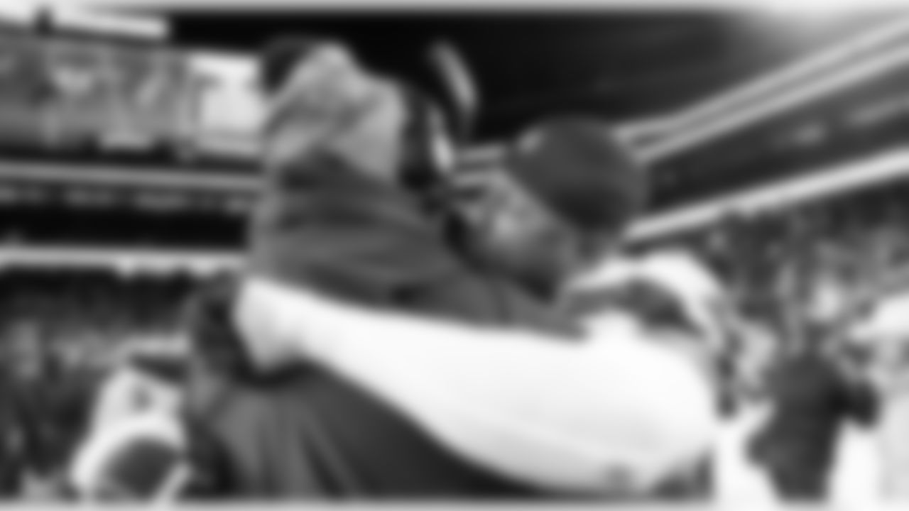 Seahawks linebacker Uchenna Nwosu hugs an assistant coach as the clock runs out on their 13-3 win over the 49ers.