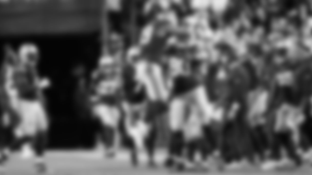 Seahawks defenders Leonard Williams and Jarran Reed celebrate after Williams chased down Commanders quarterback Jayden Daniels on fourth down, giving up the ball.