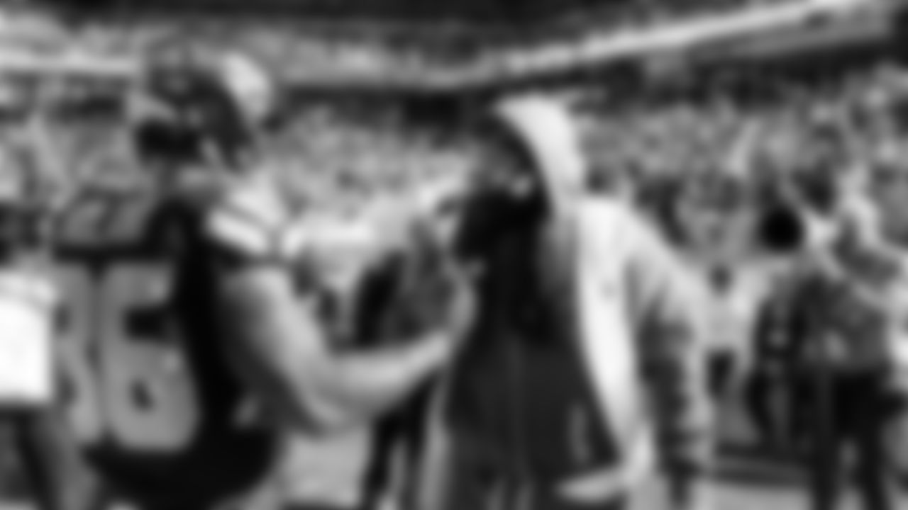 Running back George Holani is greeted by Seahawks Legend Marshawn Lynch during pregame warmups.