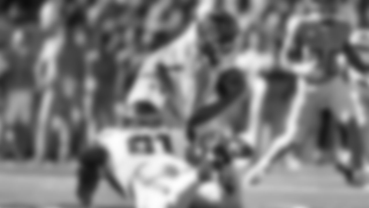 Seattle's Byron Murphy II drags down Titans quarterback Cam Ward for a sack.